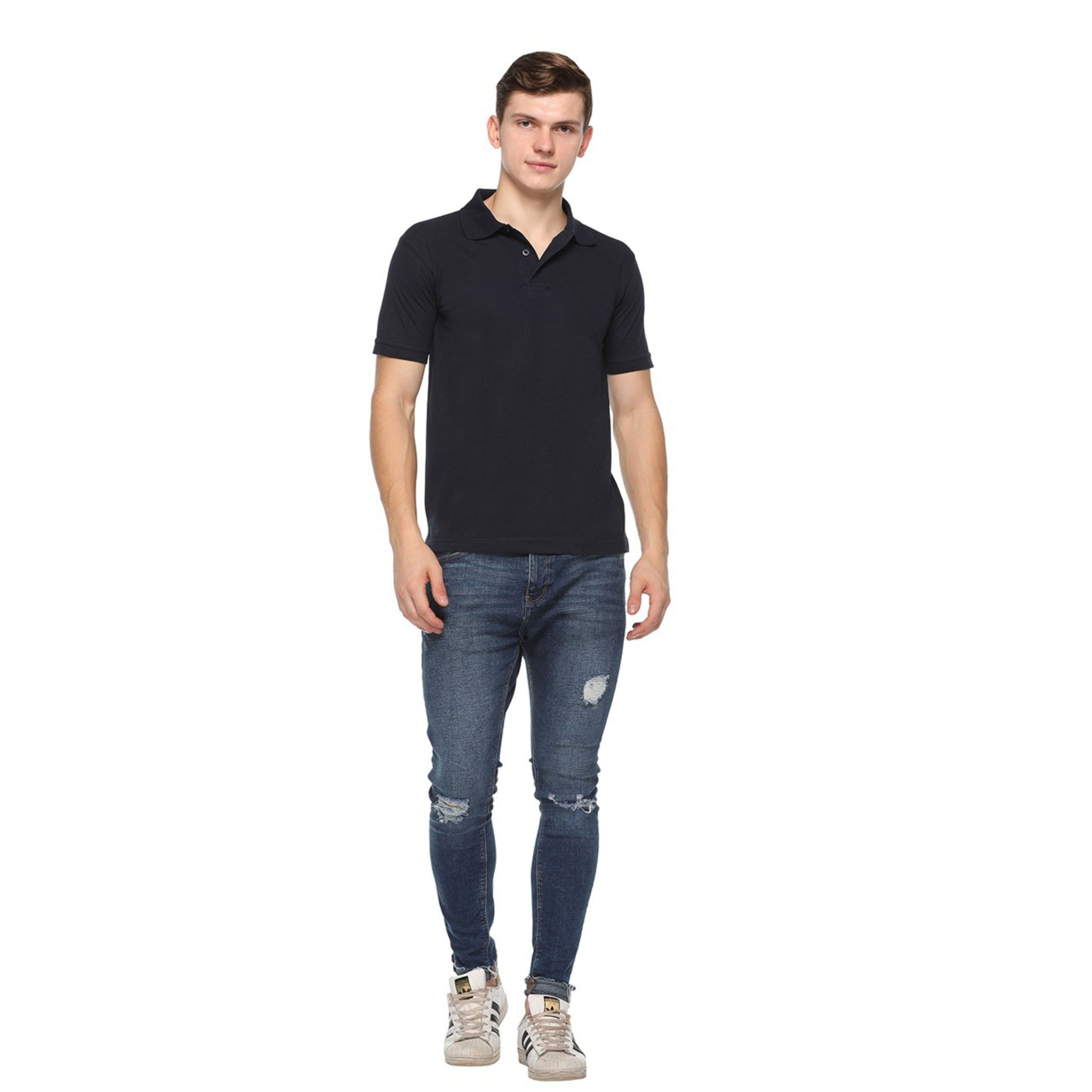 Man wearing a black polo t shirt and blue jeans on a white background