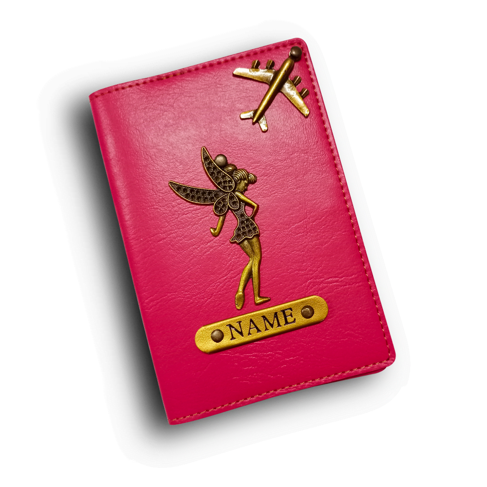 Pink passport holder with gold fairy and airplane design on a white background