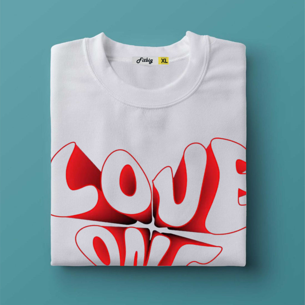 Folded white t-shirt with red 'LOVE' graphic on a teal background