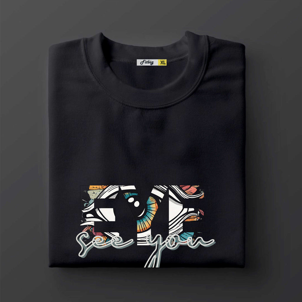 Black t shirt with colorful graphic design on a dark background