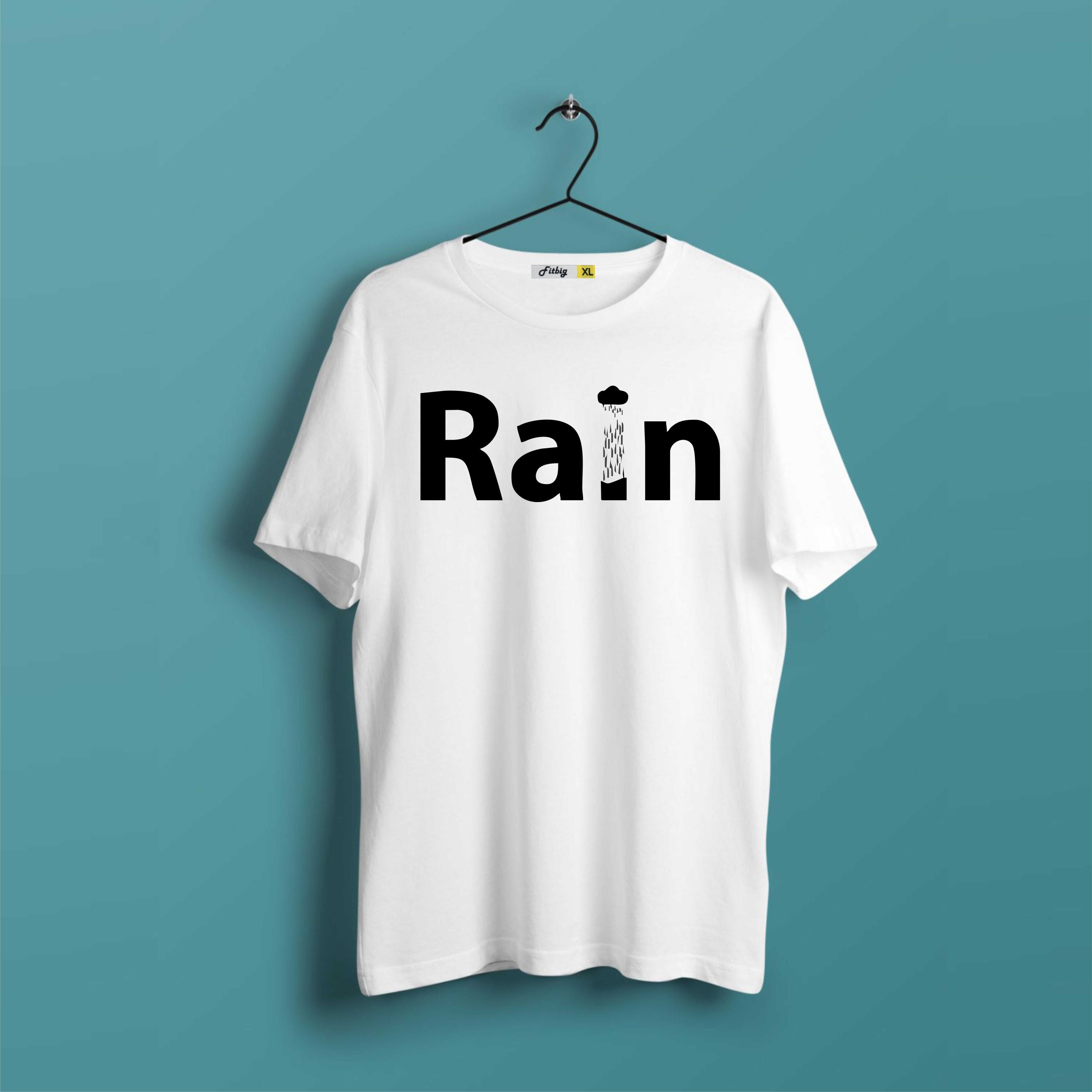 White t-shirt with 'Rain' printed on it hanging against a teal background