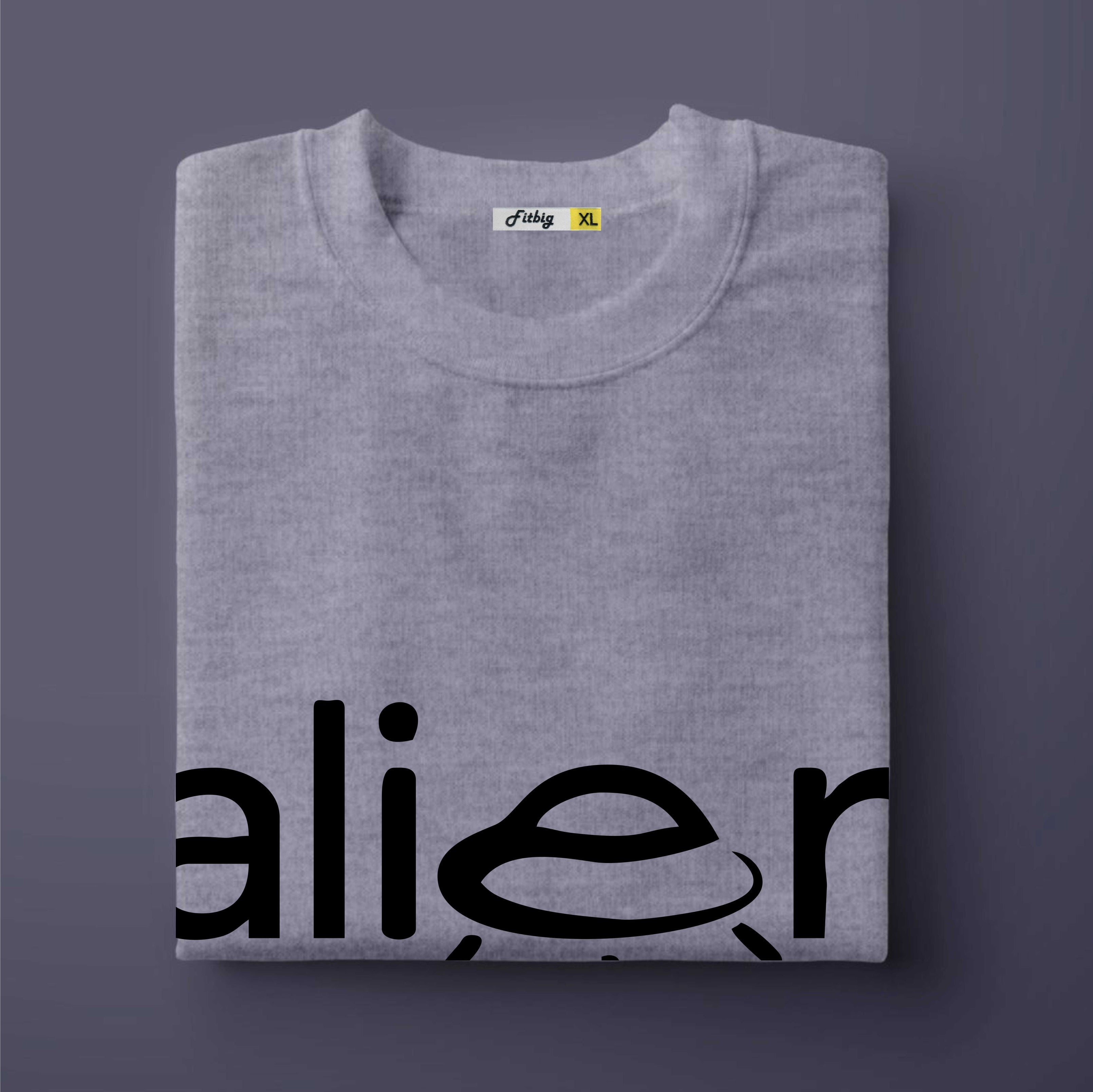 Folded gray t-shirt with 'alien' text on a dark purple background