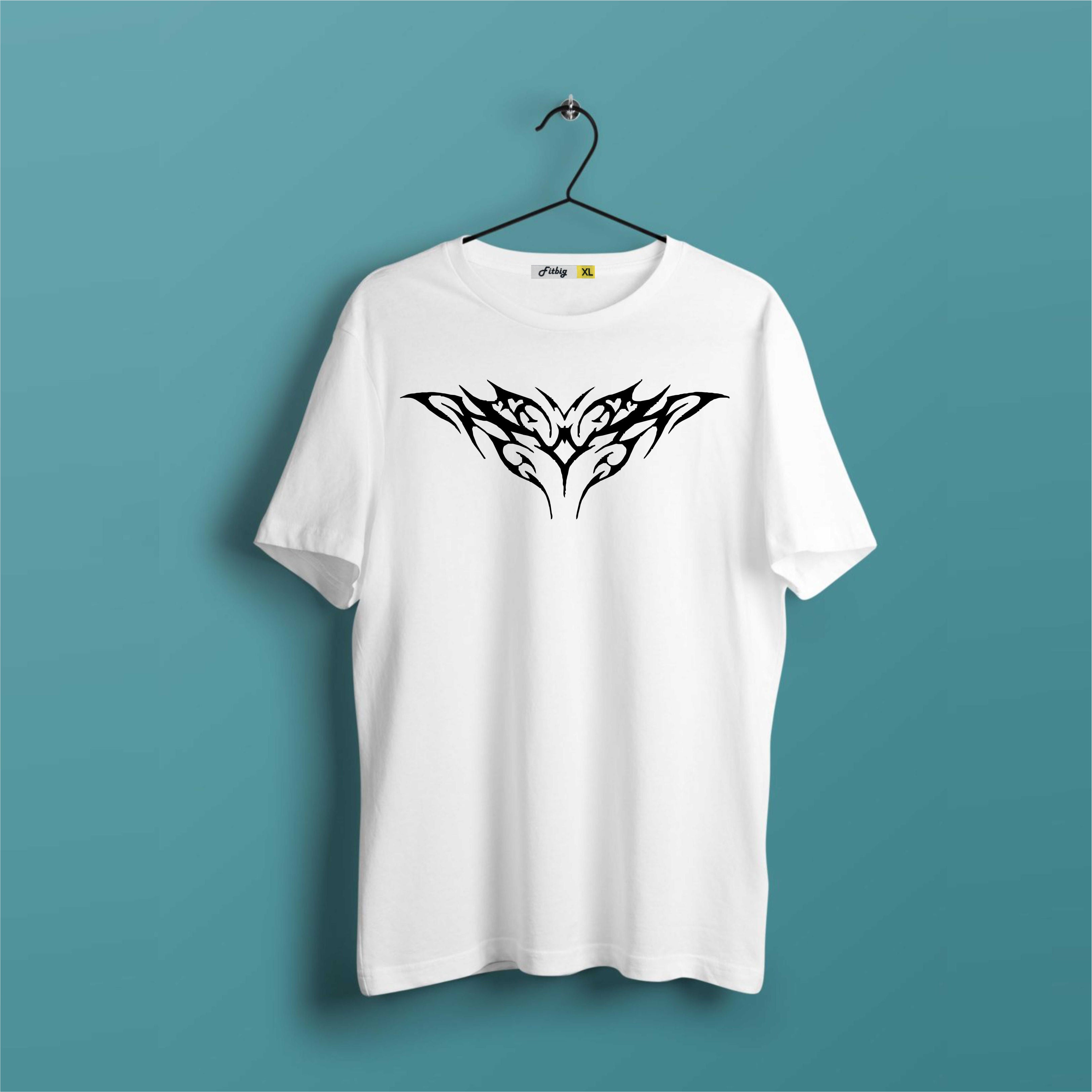 White t-shirt with black tribal design on a hanger against a teal background