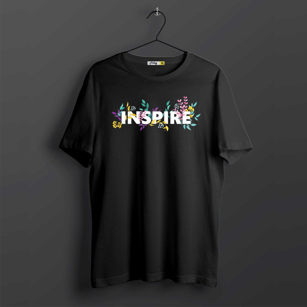 Black t-shirt with 'INSPIRE' text and floral designs on a dark background