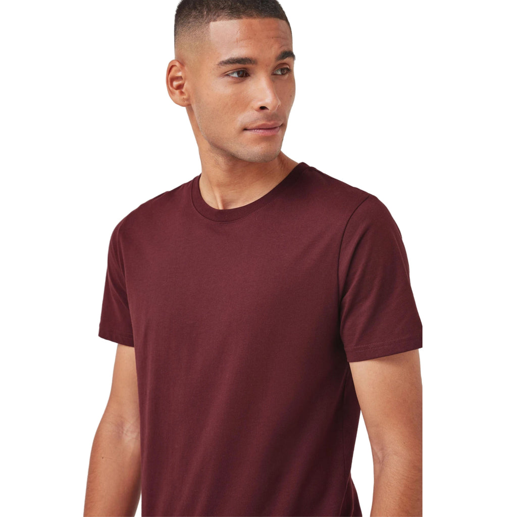 Man wearing a maroon t-shirt on a white background