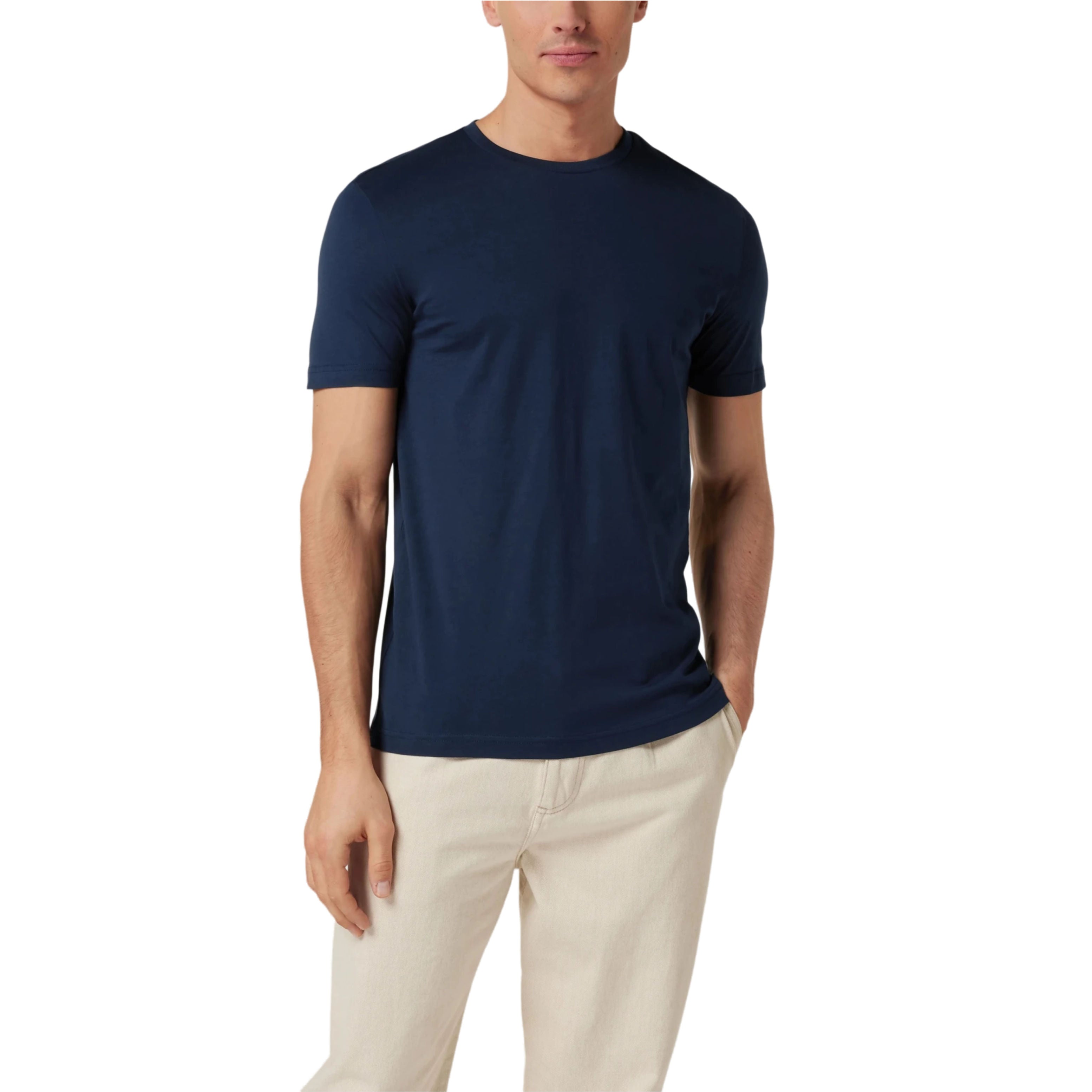 Man wearing a navy blue t-shirt and beige pants on a white background